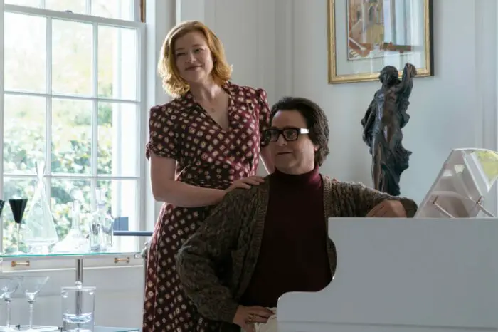 Sheila (Sarah Snook) and Ty (Galifianakis) pose for a family portrait by a white grand piano.