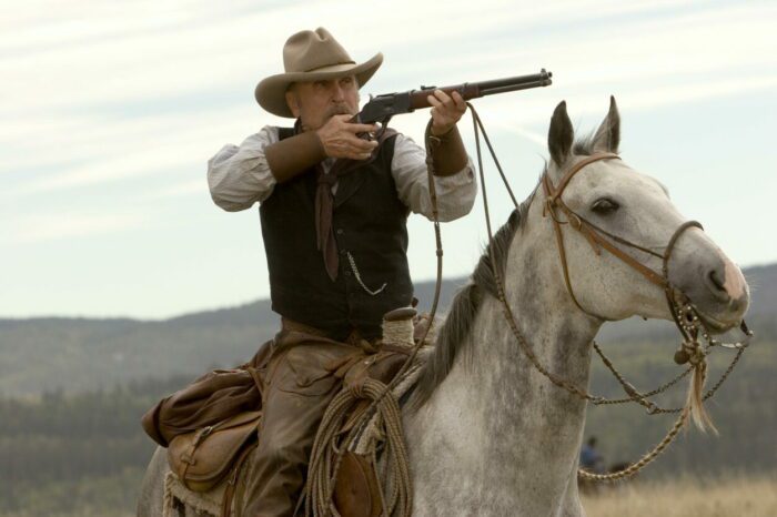 Prent sits on horseback, aiming his rifle.
