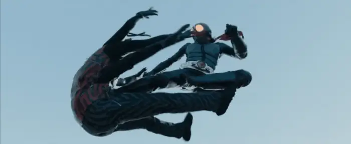 Kamen Rider (Sosuke Ikematsu) using the iconic Rider Kick on Spider-Aug (Nao Ōmori)