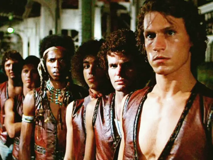 The Warriors stand in a line on a street corner.
