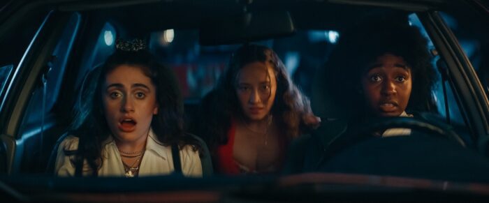 Rachel Sennott stars as PJ, Havana Rose Liu as Isabel and Ayo Edebiri as Josie in a car at nighttime in BOTTOMS.