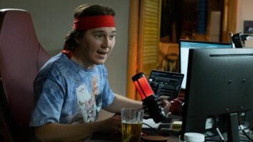 Paul Dano talks into a microphone at his computer