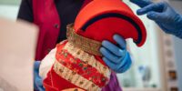 A Sámi artifact being handled with gloves