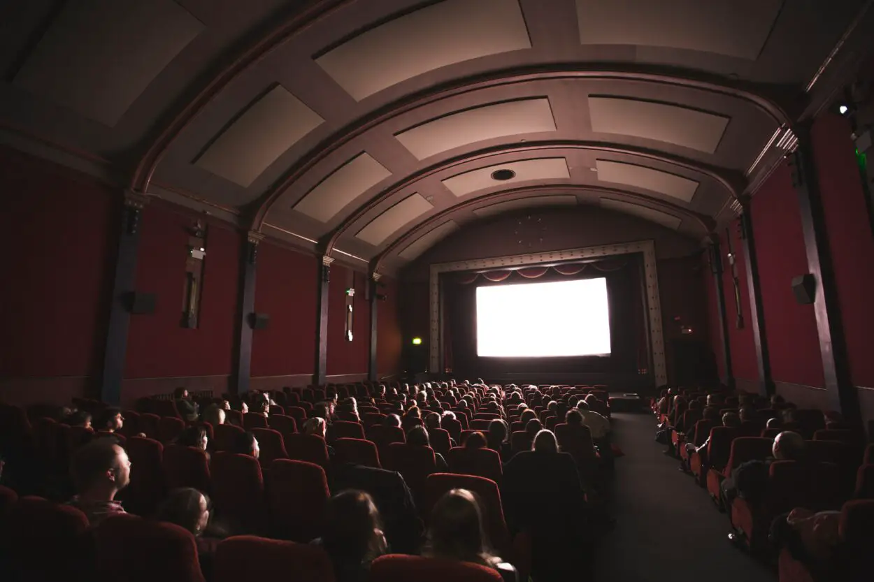 A large theater is nearly full before a movie.