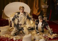 Nicholas Galitzine as Prince Henry and Taylor Zakhar Perez as Alex Claremont-Diaz shocked crouched on the floor covered in cake