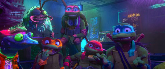 Four ninja turtle friends gather together over pizza in "Teenage Mutant Ninja Turtles: Mutant Mayhem"
