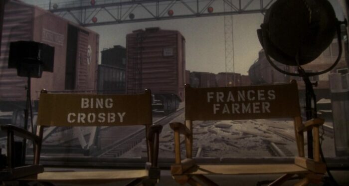 Empty movie chairs with the names Bing Crosby on one and Frances Farmer on the other.