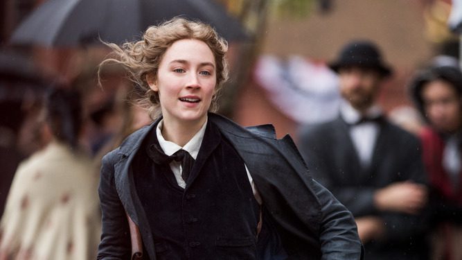 Saoirse Ronan as Jo March runs down the street in Little Women.