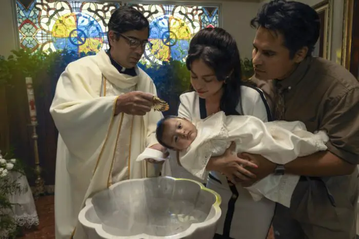 A husband and wife hold a baby for baptism in A Million Miles Away
