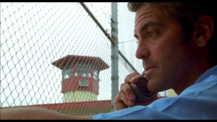 A man makes a phone call from inside a prison.