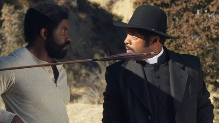 Two men look at each other next to an shot arrow in Outlaw Johnny Black