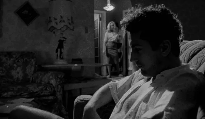Jake LaMotta (Robert DeNiro) waits for his wife Vicky (Cathy Moriarty) to come home after beating her.