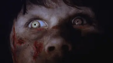 Light glows on the eyes of a possessed young girl in The Exorcist