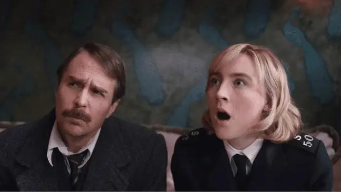 Saoirse Ronan and Sam Rockwell, wearing constable uniforms, express hock in See How They Run