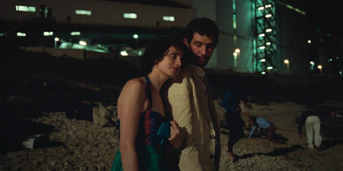La Chimera. Josh O'Connor as Arthur and Carol Duarte as Italia.at the beach at night.