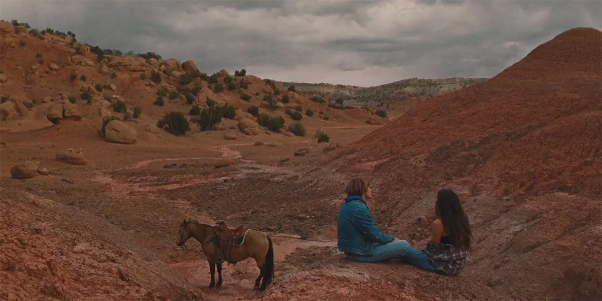 Dylan and Sky sit on a mountain