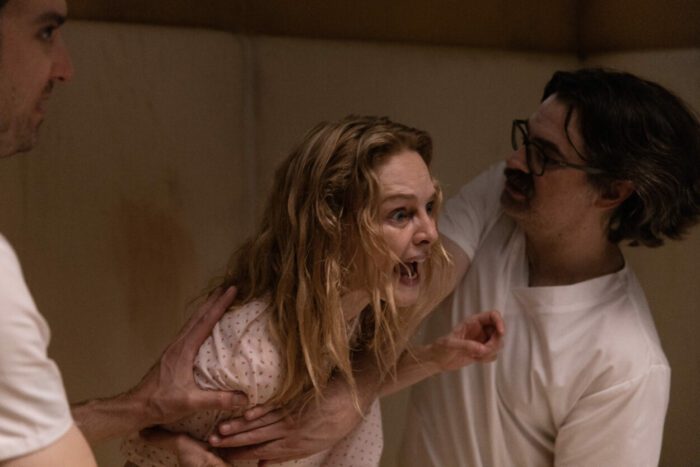 A screaming Elizabeth Derby (Heather Graham) is restrained by orderlies in Suitable Flesh.
