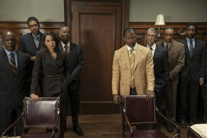 Two legal teams stand apart from each other in a courtroom