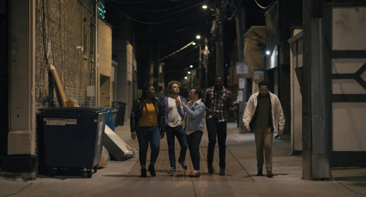 A group of friend traverse a Chicago alley in Saturday Night Inside Out