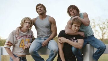 Zac Efron, Jeremy Allen White, Harris Dickinson, and Stanley Simons pose on a bench as the Von Erich brothers in the A24 film The Iron Claw