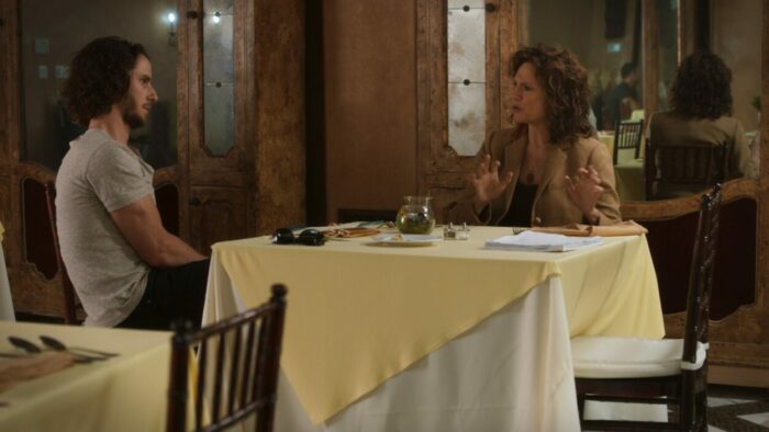Loren and Rose face each other across the table.