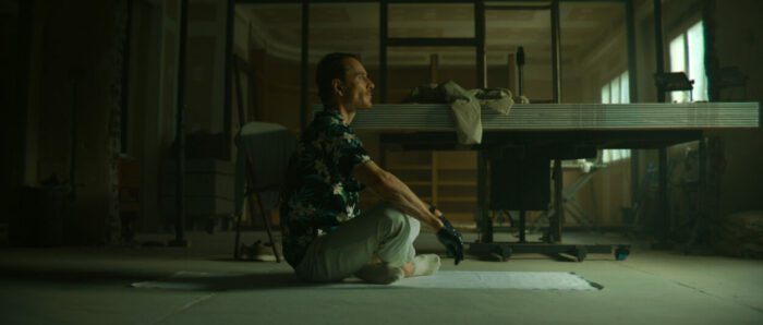 A man sits calmly in a room in The Killer.
