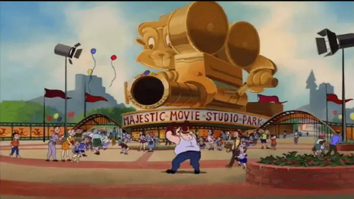 The Universal Studios spoof, "Majestic Movie Studio Park," where the Chipmunks play and perform. Children and families walk around the entrance of the theme park. The park's mascot, Sammy Squirrel, sits on top of the entrance as a giant, golden statue.