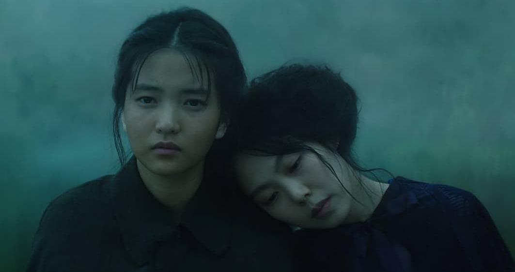 film still from The Handmaiden (2016) showing Lady Hideko leaning her head on the shoulder of Sook-Hee
