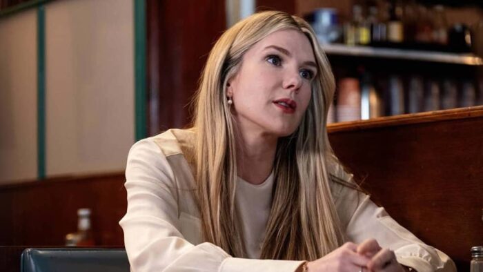 Lily Rabe as Julia, sitting in an office in Downtown Owl. 