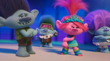 Four trolls practice a song number in Trolls Band Together