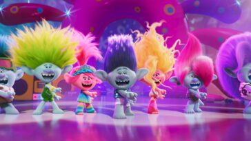 Seven trolls dance together for a big song in Trolls Band Together