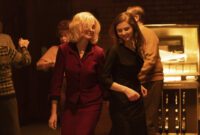 Still from EILEEN showing Rebecca (Anne Hathaway) and Eileen (Thomasin Mackenzie) dancing together in a bar.