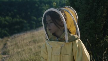 Lucia (Sofia Otero) in her beekeepers outfit