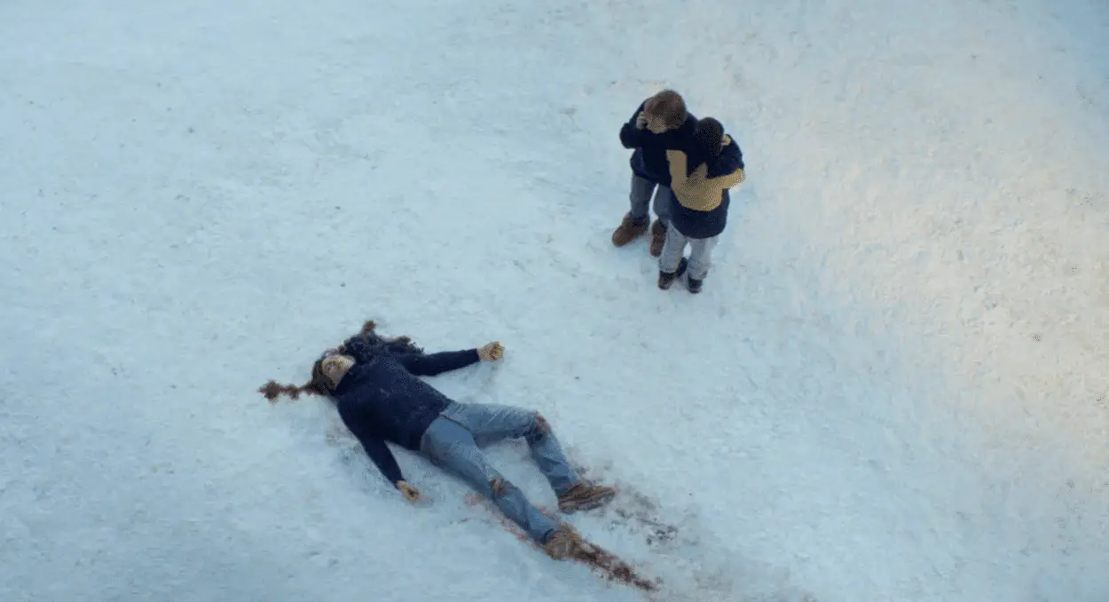 A stricken mother and son stand in the snow over a man's prostrate body