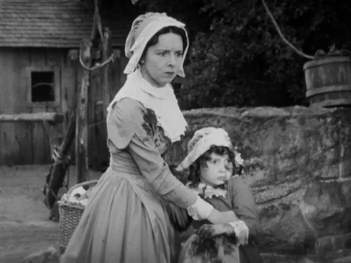 Hester Prynne (Colleen Moore) holds little Pearl (Cora Sue Collins) in The Scarlet Letter.