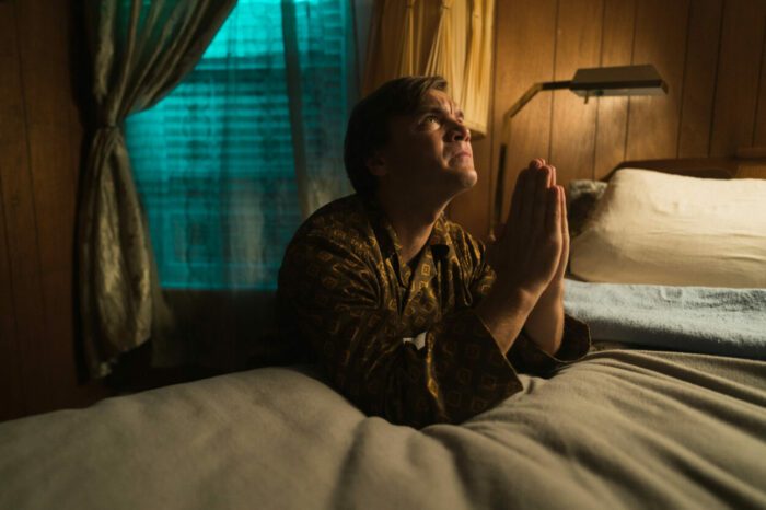 Image from WALDEN depicting Walden (Emile Hirsch) praying on his bed. 