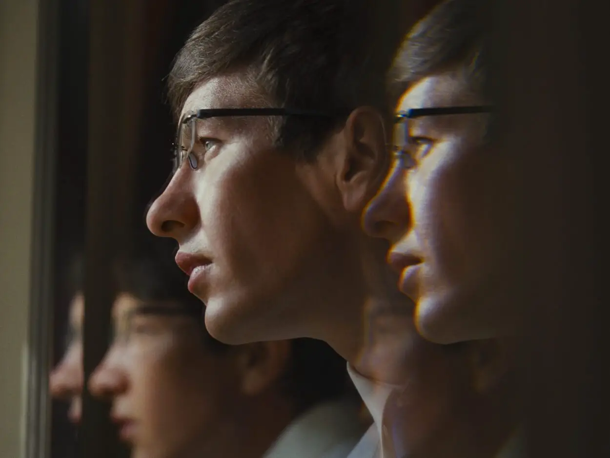 Barry Keoghan as Oliver Quick staring out a window