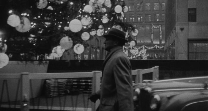 Frank (Allen Baron) strides through the streets of New York City at Christmastime.