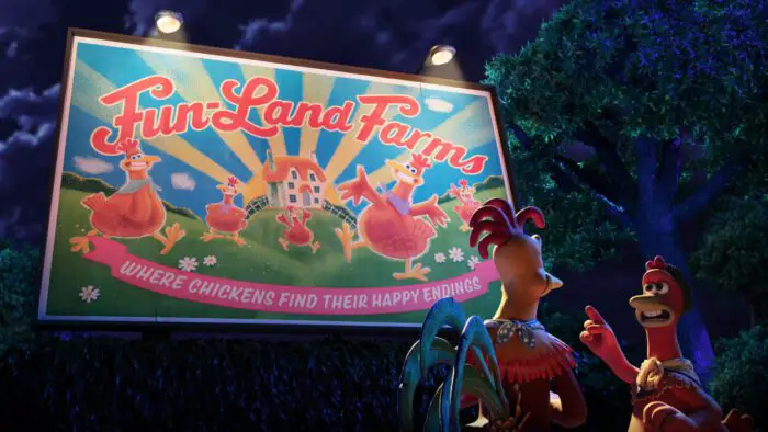 Rocky and Ginger voiced by Zachary Levi and Thandiwe Newton in Chicken Run: Dawn of the Nugget (2023). Courtesy of Netflix. Chicken and a rooster observing the billboard for Fun-land Farms which reads, "Where chickens find their happy endings."