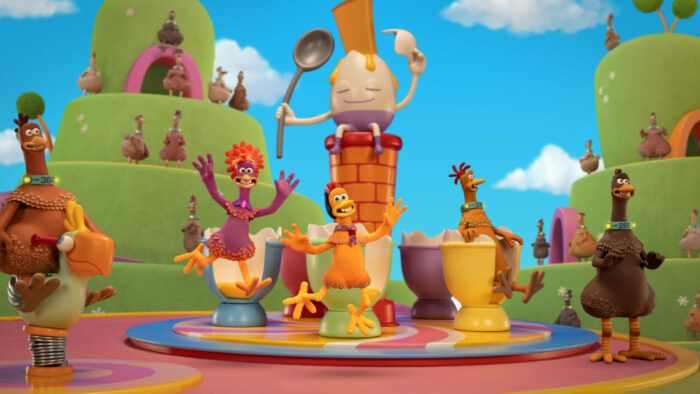 Frizzle and Molly voiced by Bella Ramsey and Josie Sedgwick-Davies in Chicken Run: Dawn of the Nugget (2023). Courtesy of Netflix. Frizzle and Molly enjoying Fun-land Farms surrounded by other playing chickens, many riding a teacup merry-go-round.