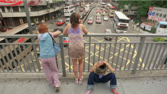 The girls look over a city street.