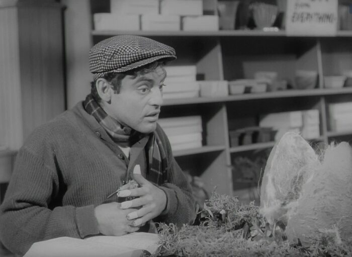 Seymour (Jonathan Haze) talks to his plant Audrey Jr. in The Little Shop of Horrors (1960). 