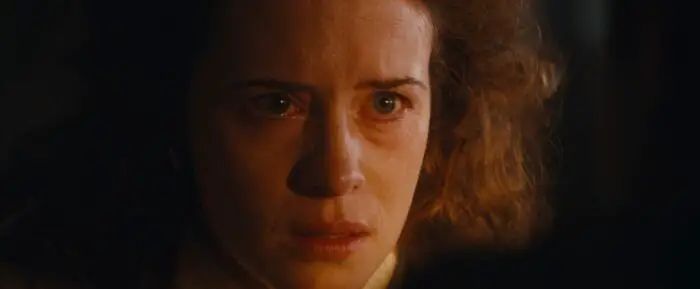 "Mum" (Claire Foy) stares at the camera, looking distressed.