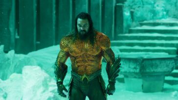JASON MOMOA as Aquaman in Warner Bros. Pictures’ action adventure “Aquaman and the Lost Kingdom,” a Warner Bros. Pictures release. The comic book character stands in a frozen palace wearing his signature orange and green armor.