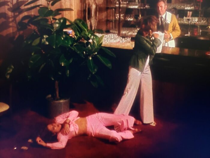Marki Bey, Betty Anne Rees, and Frank Beetson as Diana "Sugar" Hill, Celeste, and Bartender in Sugar Hill (1974). Screen capture off Amazon. An American International Picture/MGM. Following a barroom catfight, Sugar Hill stands victorious over the defeated Celeste while the Bartender idly watches.