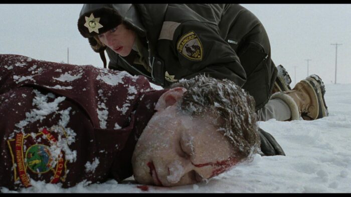 Frances McDormand in the background of a dead body in Fargo