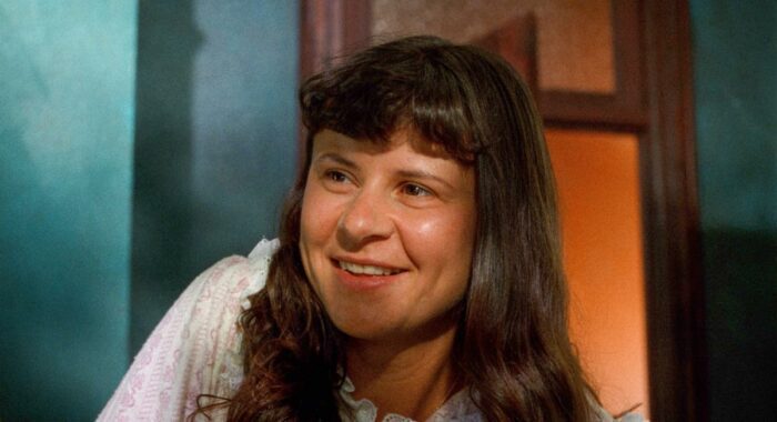 Tracey Ullman as Catherine,, smiling in her nightgown, in Household Saints. Photo: courtesy Kino Lorber.