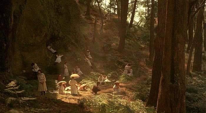 A shot from film Picnic at Hanging Rock showing women in the forest.