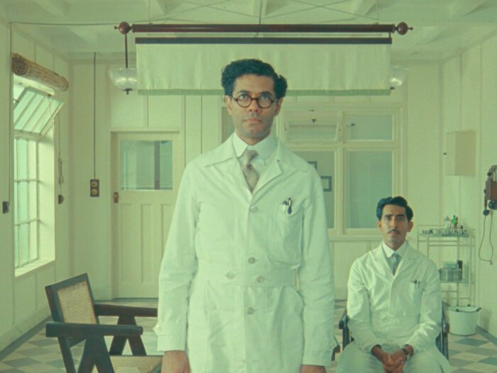 (L to R) Richard Ayoade as Dr. Marshall and Dev Patel as Dr. Chatterjee in The Wonderful Story of Henry Sugar.