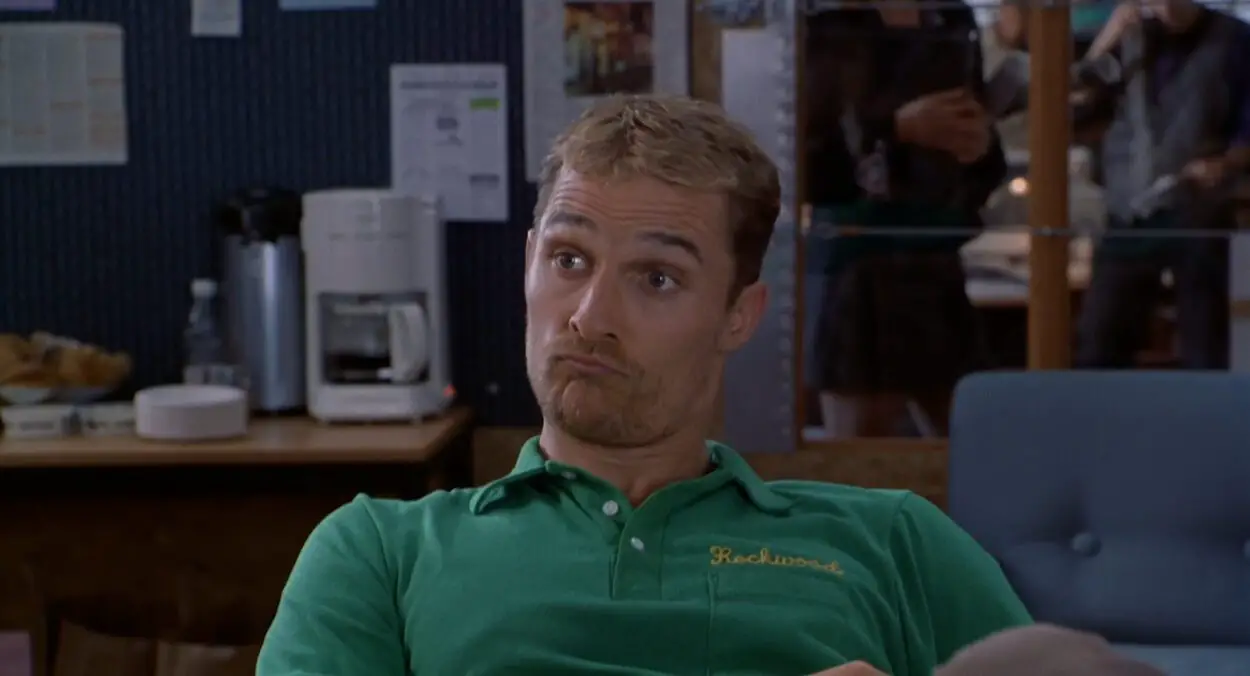Ed makes a funny face while wearing a green polo shirt in EDtv